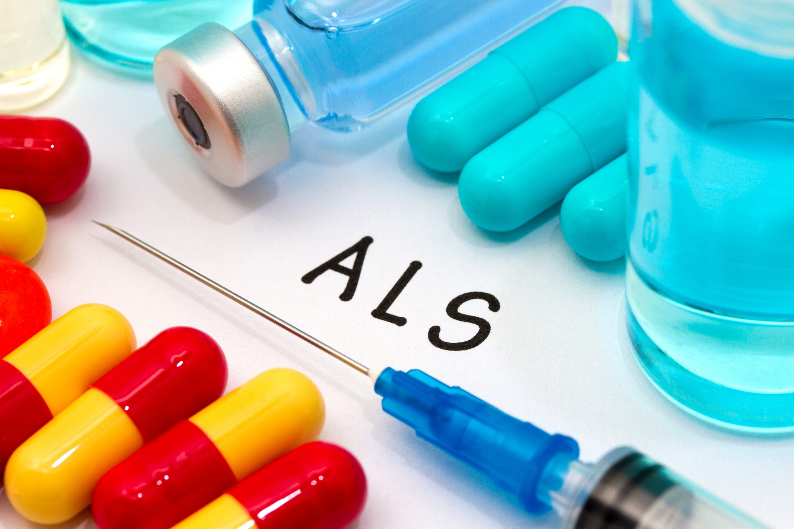 Letters 'ALS' surrounded by capsules and a syringe