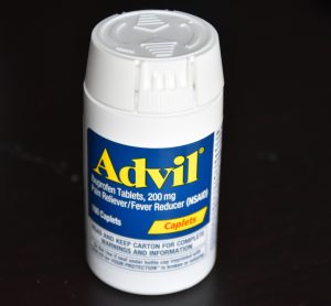 A bottle of Advil over the counter pain medication [Credit: Rajarajan Kannanb/Shutterstock.com].