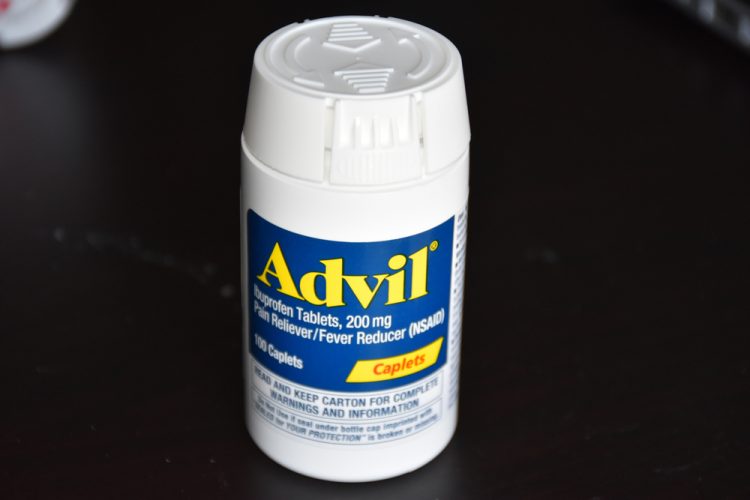A bottle of Advil over the counter pain medication [Credit: Rajarajan Kannanb/Shutterstock.com].