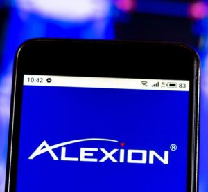 Alexion Pharmaceuticals company logo displayed on a smart phone screen [Credit: IgorGolovniov/Shutterstock.com].