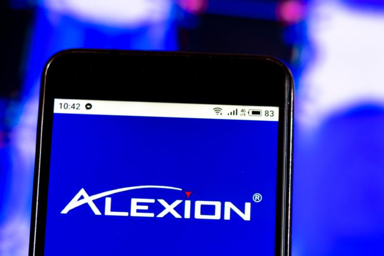 Alexion Pharmaceuticals company logo displayed on a smart phone screen [Credit: IgorGolovniov/Shutterstock.com].