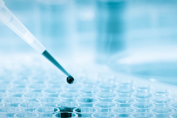 micropipette dropping liquid into 96-well plate - idea of assays