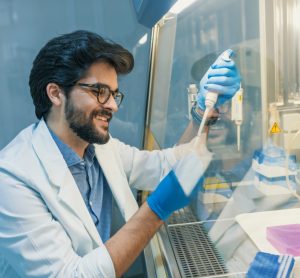 Scientist pipetting liquid in a Biological safety cabinet