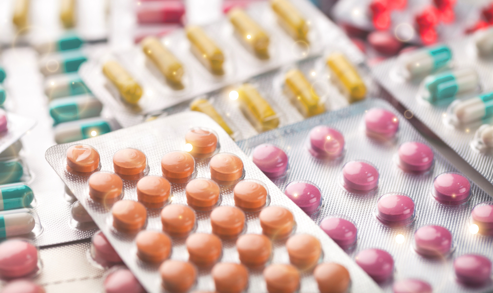 Various colours and shapes of pills and capsules in blister packaging