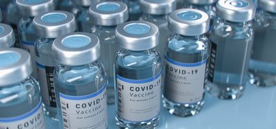 Vials labelled 'COVID-19 Vaccine' lined up in rows - idea of vaccine supply