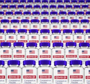 Vials labelled with the US flag and 'COVID-19 VACCINE) - idea of US vaccines/vaccine allocation