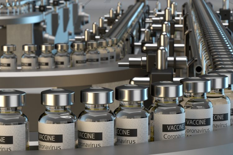 Vials labelled 'CORONAVIRUS VACCINE' on a production line - idea of COVID-19 vaccine manufacturing