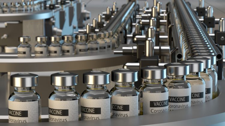 Vials labelled 'CORONAVIRUS VACCINE' on a production line - idea of COVID-19 vaccine manufacturing