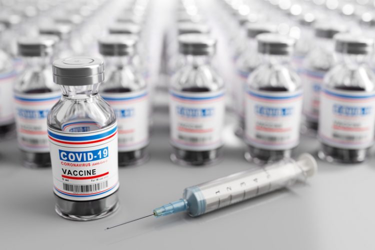 Lines of vials stretching off into the distance, all labelled 'COVID-19 Vaccine' - idea of COVID-19 vaccine supply/manufacturing