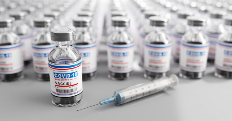 Lines of vials stretching off into the distance, all labelled 'COVID-19 Vaccine' - idea of COVID-19 vaccine supply/manufacturing