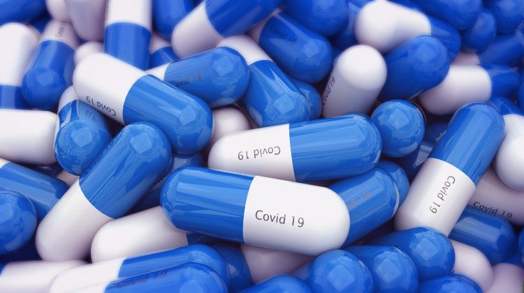 Blue and white capsules labelled 'COVID-19' - idea of tablet COVID-19 vaccine