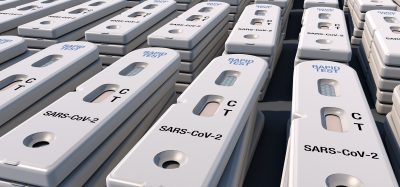 Piles of Antigen rapid diagnostic tests labelled with 'SARS-CoV-2' - indicating they are for use in testing for COVID-19