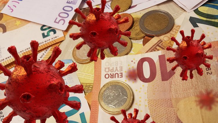 Red coronavirus particles overlaid on euro notes