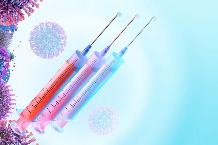 concept of COVID-19 vaccine booster - three syringes of liquid (vaccine doses) next to a series of SARS-CoV-2 virus particles