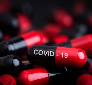 red and black capsules labelled COVID-19