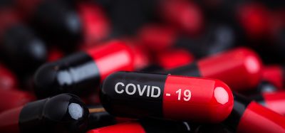 red and black capsules labelled COVID-19
