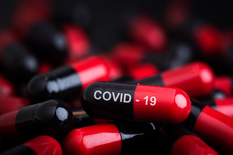 red and black capsules labelled COVID-19