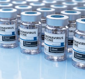 Vaccine vials labelled 'COVID-19 vaccine' lined up in rows