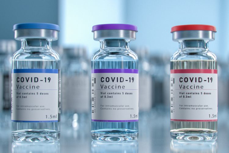 Three vials each labelled 'COVID-19 Vaccine'