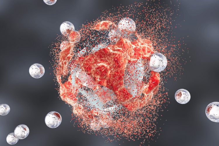 3D illustration of a red tumour cell being destroyed by white nanoparticles