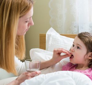 Child with cystic fibrosis being given antibiotic