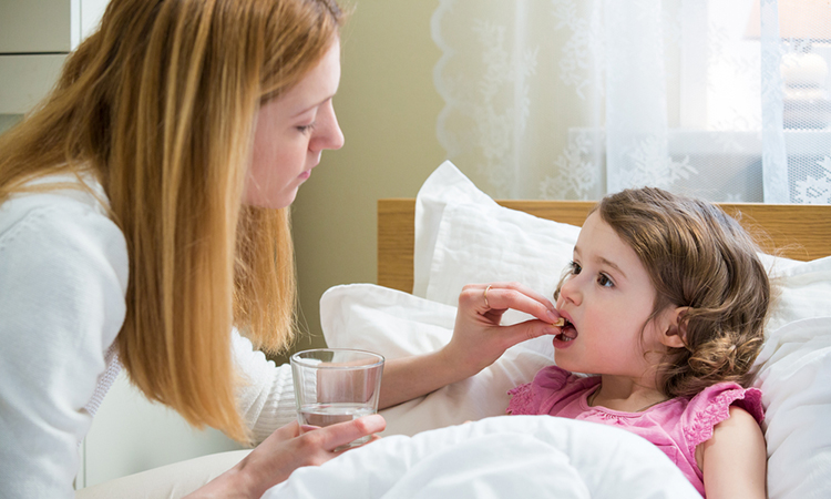 Child with cystic fibrosis being given antibiotic