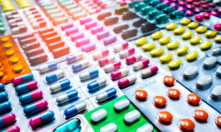 many packets of multicoloured tablets laid out together