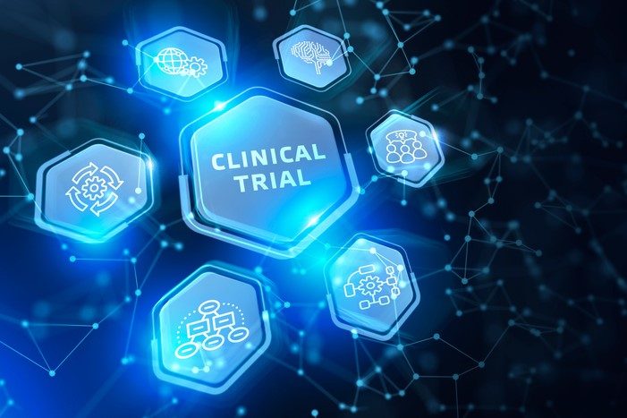 Technology/database concept - button labelled 'clinical trial' surrounded by a number of other icons on an abstract technology background