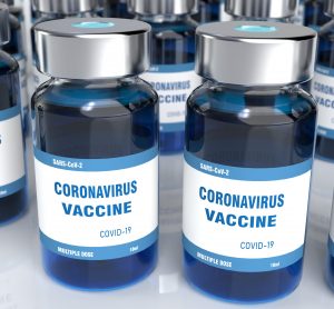 vials of blue liquid labelled 'CORONAVIRUS VACCINE COVID-19'