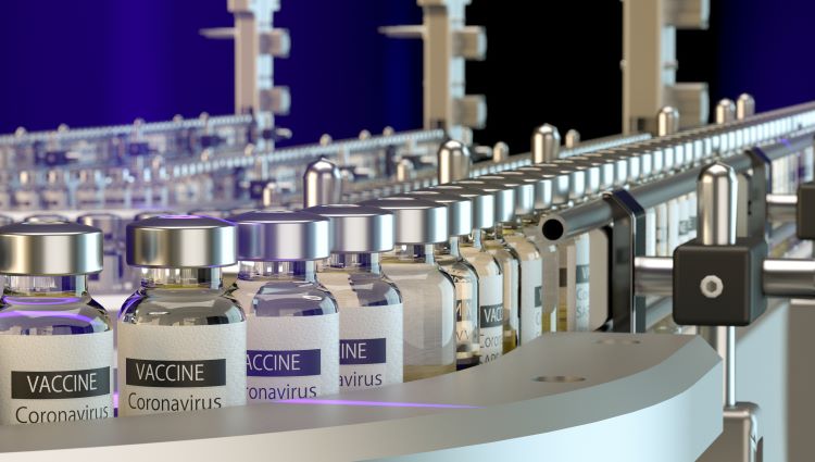 vials labelled 'CORONAVIRUS VACCINE' on a production line