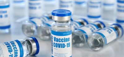 Vials with white and blue labels reading 'COVID-19 Vaccine'