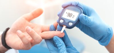 Diabetes patient's blood glucose level being checked by doctor