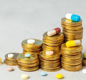 stacks of US coins with drugs placed around and on top