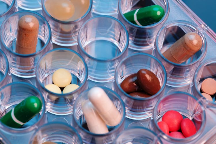 color pills and capsules in plastic tray