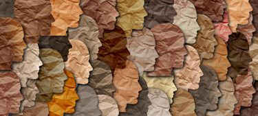 Diversity, Equity and Inclusion concept - human profiles cut out in paper of various different skin tones