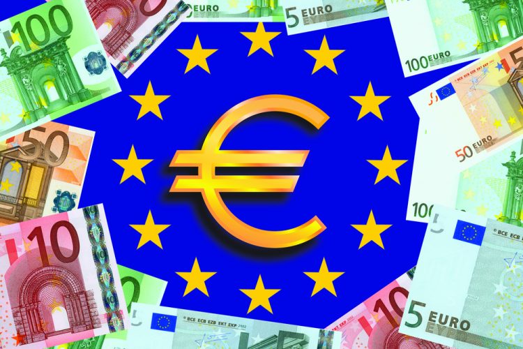 Symbol for euros in centre of European Union flag (blue with a central circle of golden stars) surrounded by Euro bank notes - idea of EU funding