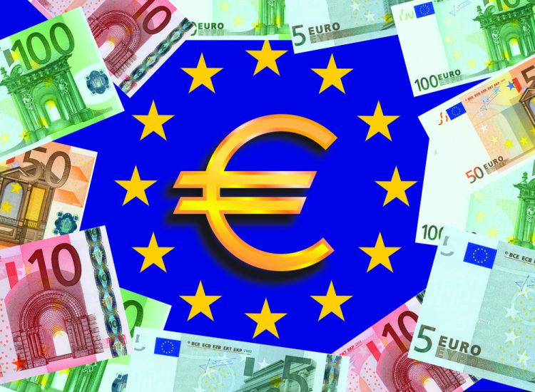 Symbol for euros in centre of European Union flag (blue with a central circle of golden stars) surrounded by Euro bank notes - idea of EU funding