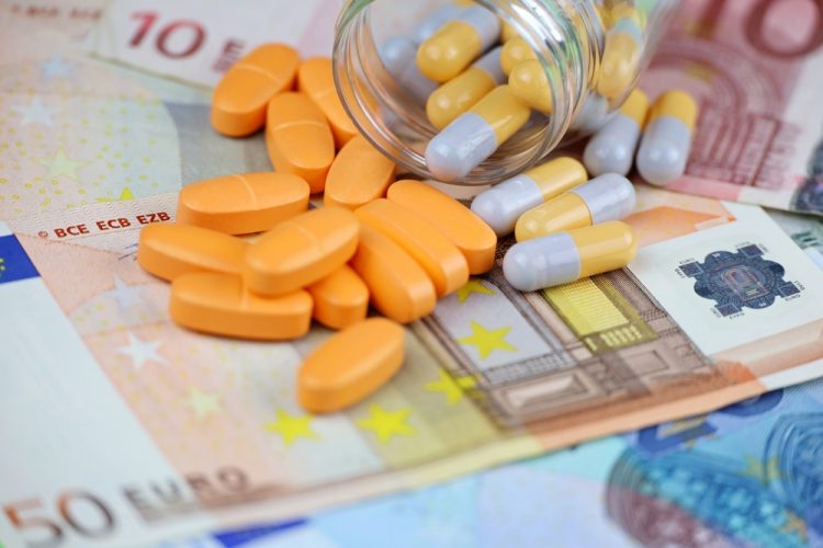 Concept of EU Drug pricing or cost of goods - Pills and capsules scattered from a bottle on euro banknotes