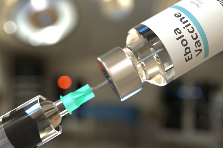 Syringe drawing from a vial labelled 'Ebola Vaccine'