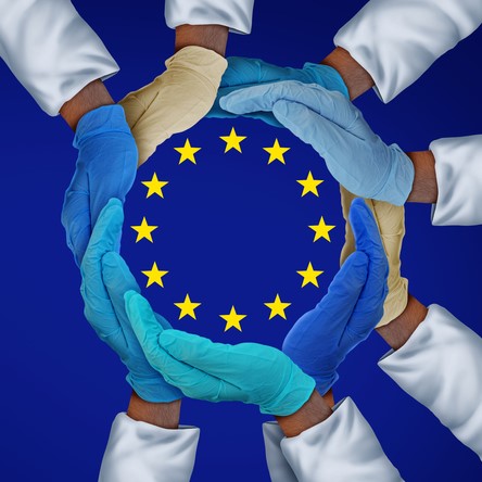 European Union flag (blue with central circle of yellow stars) with glowed hands of people in white coats surrounding the star circle - idea of European medicine/research/drug development/biopharma