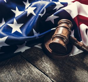 folded US flag and wooden gavel