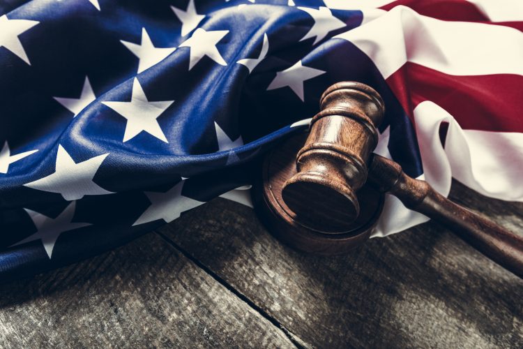 folded US flag and wooden gavel