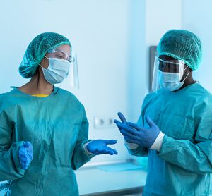 two people wearing scrubs in a cleanroom/aseptic production facility