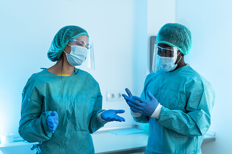 two people wearing scrubs in a cleanroom/aseptic production facility