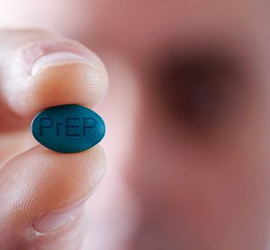 Man holding a blue tablet with 'PrEP' engraved on it