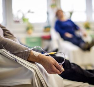 Woman with IV in her arm receiving cancer treatment