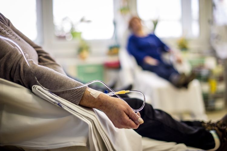 Woman with IV in her arm receiving cancer treatment