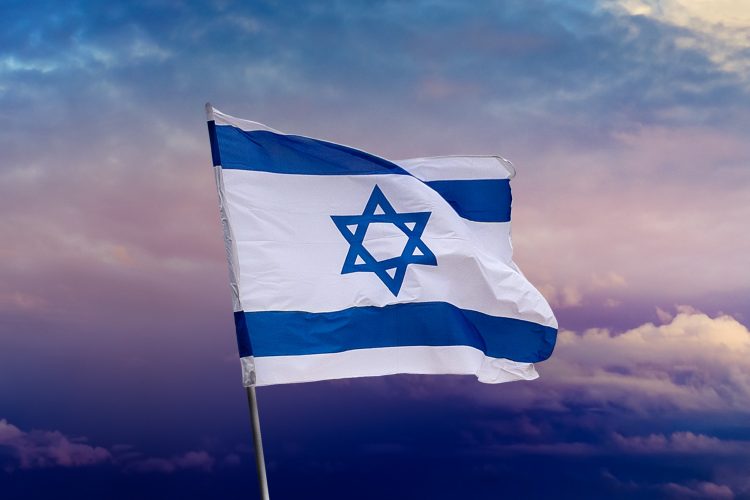 Israeli flag with blue star of David over Jerusalem on cloudy sky sunset background