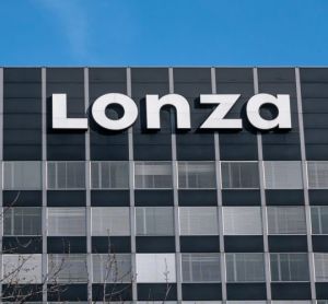 Lonza Logo on top of grey building in Basel, Switzerland [Credit: Taljat David / Shutterstock.com].