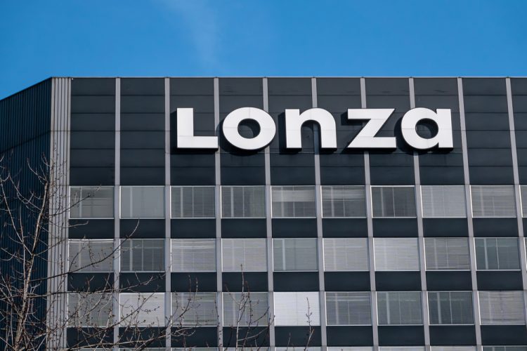 Lonza Logo on top of grey building in Basel, Switzerland [Credit: Taljat David / Shutterstock.com].